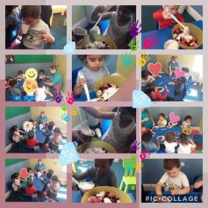 Children preparing their grown strawberries for a smoothie.