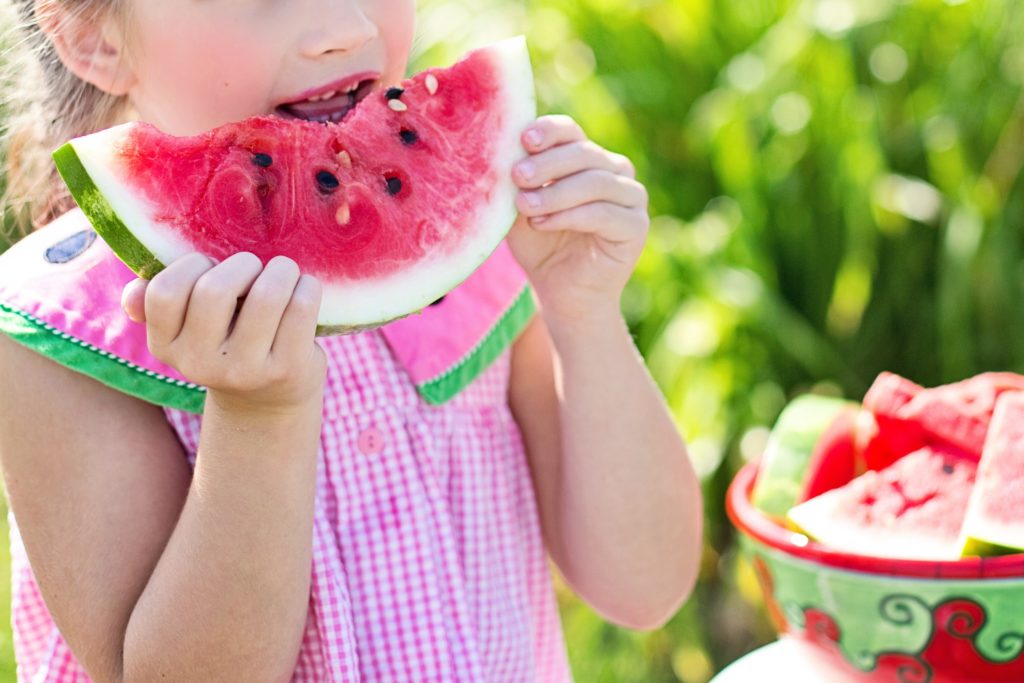 Child eating watermelon.